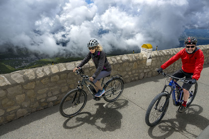 France, Vaucluse, Parc Naturel Regional du Mont Ventoux, Bedoin, cyclists at the summit of Mont Ventoux (1910m), the guide Olivier Brunaud (Egobike)