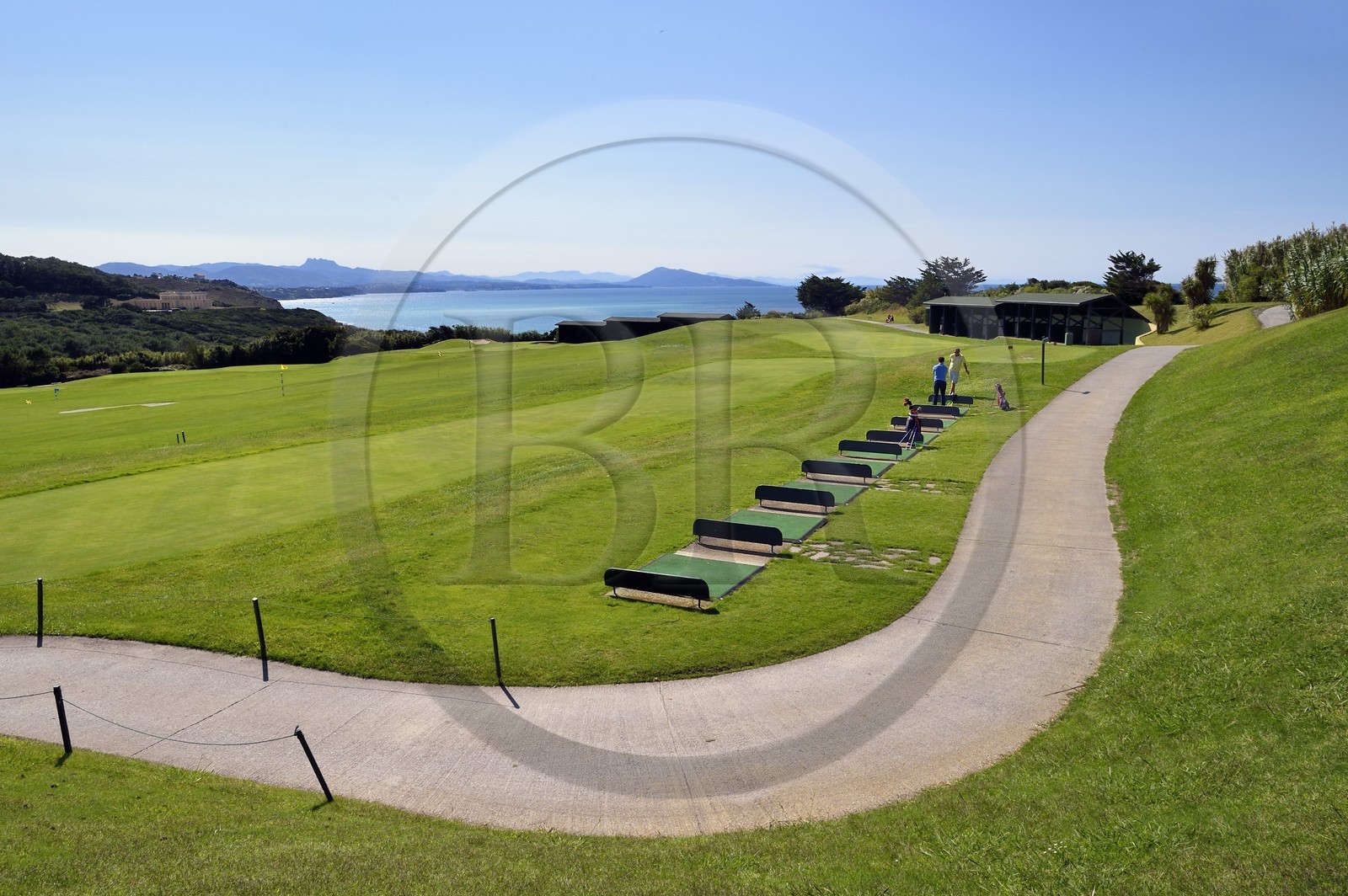 France, Pyrenees Atlantiques, Basque Country, Biarritz, golfers on the Ilbarritz golf course practice and Basque coast towards St Jean de Luz with the Pyrenees mountains in the background