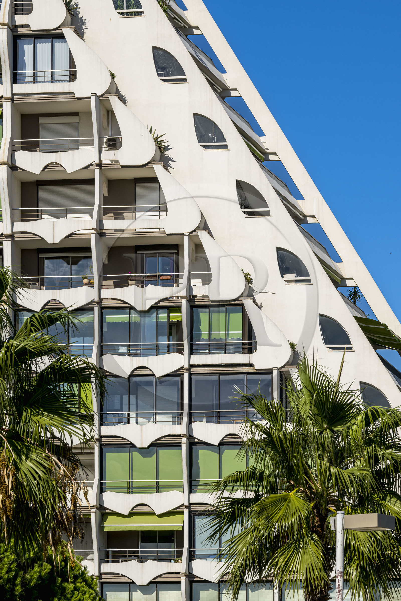France, Herault, La Grande-Motte, labeled 20th century heritage, The Great Pyramid built in 1974 by the architects Jean Balladur and Jean-Bernard Tostivint, this flagship building for the port of the seaside resort dominates the whole city, forms a curved Y plan and houses a hotel and apartments