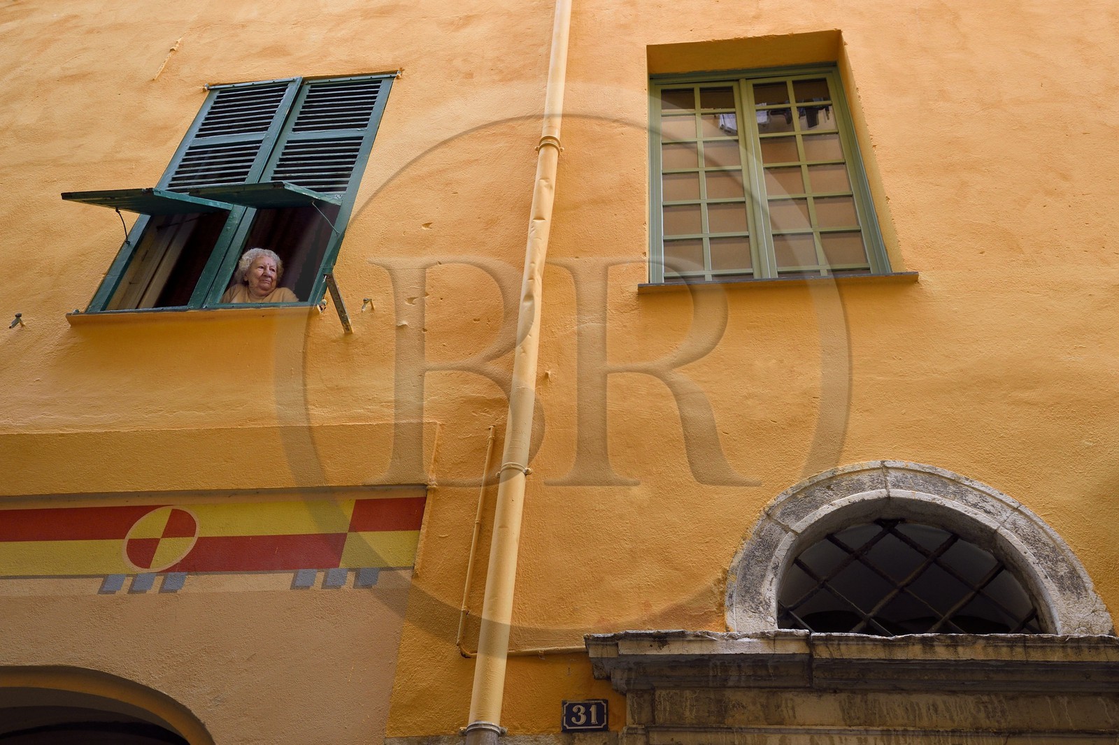France, Alpes-Maritimes, Nice, Old Town, woman at the window rue Benoit Bunicau