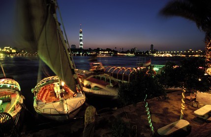Egypt, Cairo, feluccas on the Nil bank at dusk and the Cairo tower in the back
