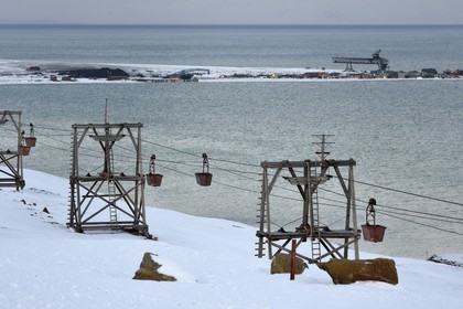 Norway, Svalbard, Spitzbergen, Longyearbyen fjord, former cableway for coal transport in carts, the port for loading coal in the background
