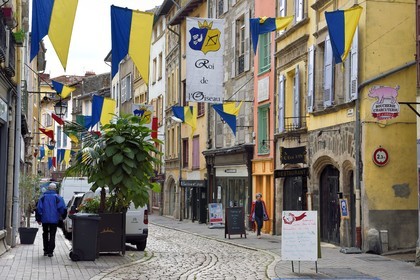 France, Haute Loire, Le Puy en Velay, Routes of Santiago de Compostela in France listed as World heritage by UNESCO, Lower town, rue Pannessac, Banner announcing the feast of the Roi de l'Oiseau (King of the Bird)