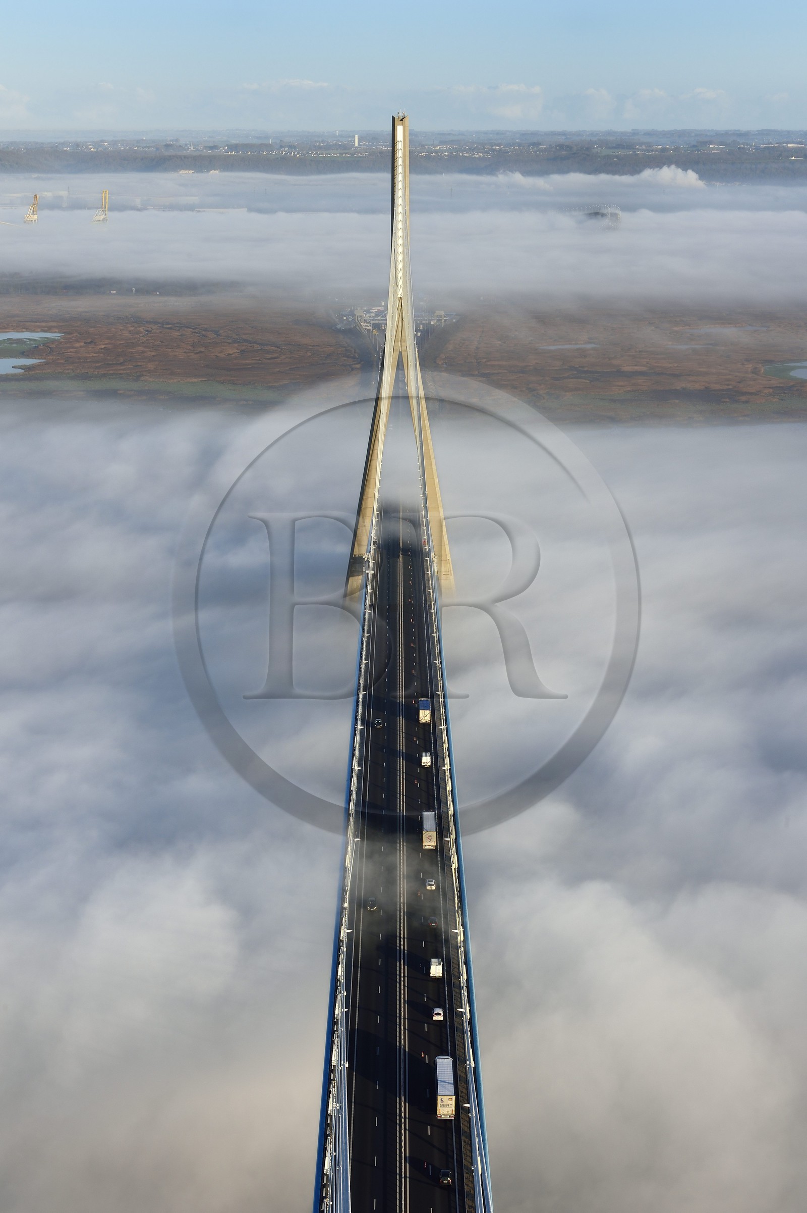 France, between  Calvados and Seine Maritime, the Pont de Normandie (Normandy Bridge) spans the and emerges from a sea of clouds, the Natural Reserve of the Seine estuary in the background