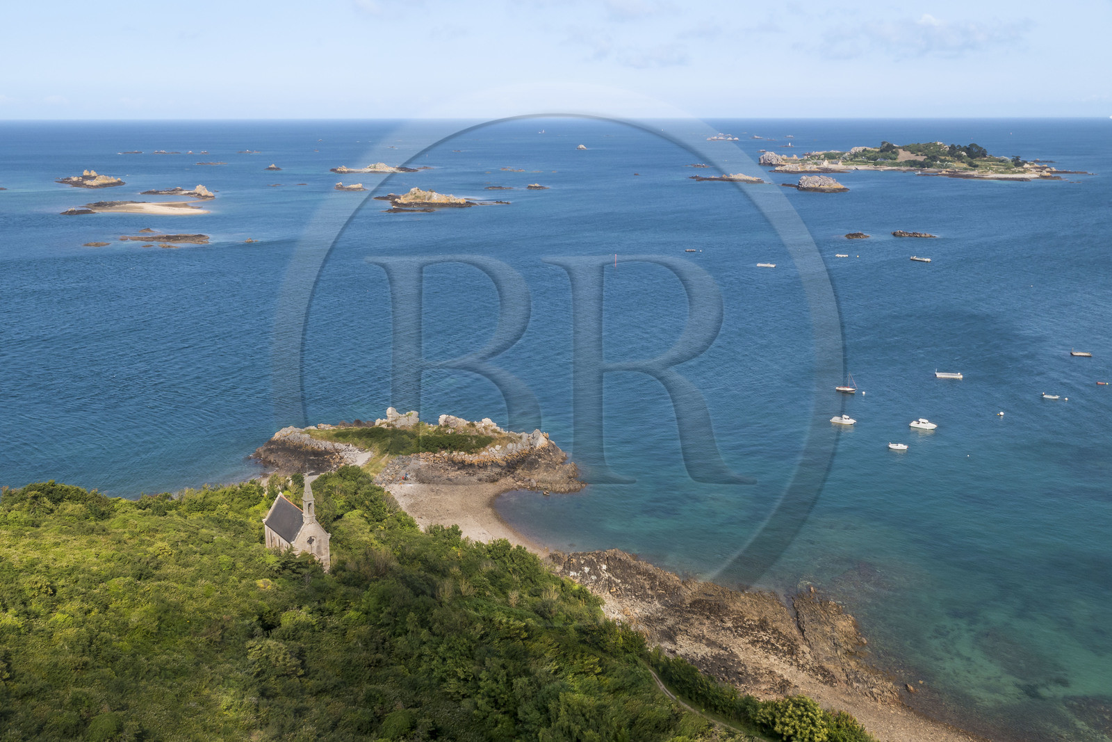 France, Cotes d'Armor, Ploubazlanec, chapel and Pointe de la Trinité, in the background the Island of Saint-Riom and the multiple rocks that surround it (aerial view)