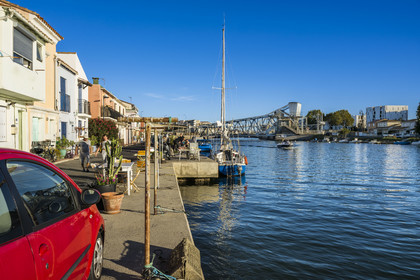 France, Herault, Sete, la Pointe Courte district, fishing district on the banks of the Etang de Thau, exit from the canal into the pond with the railway bridge in the background