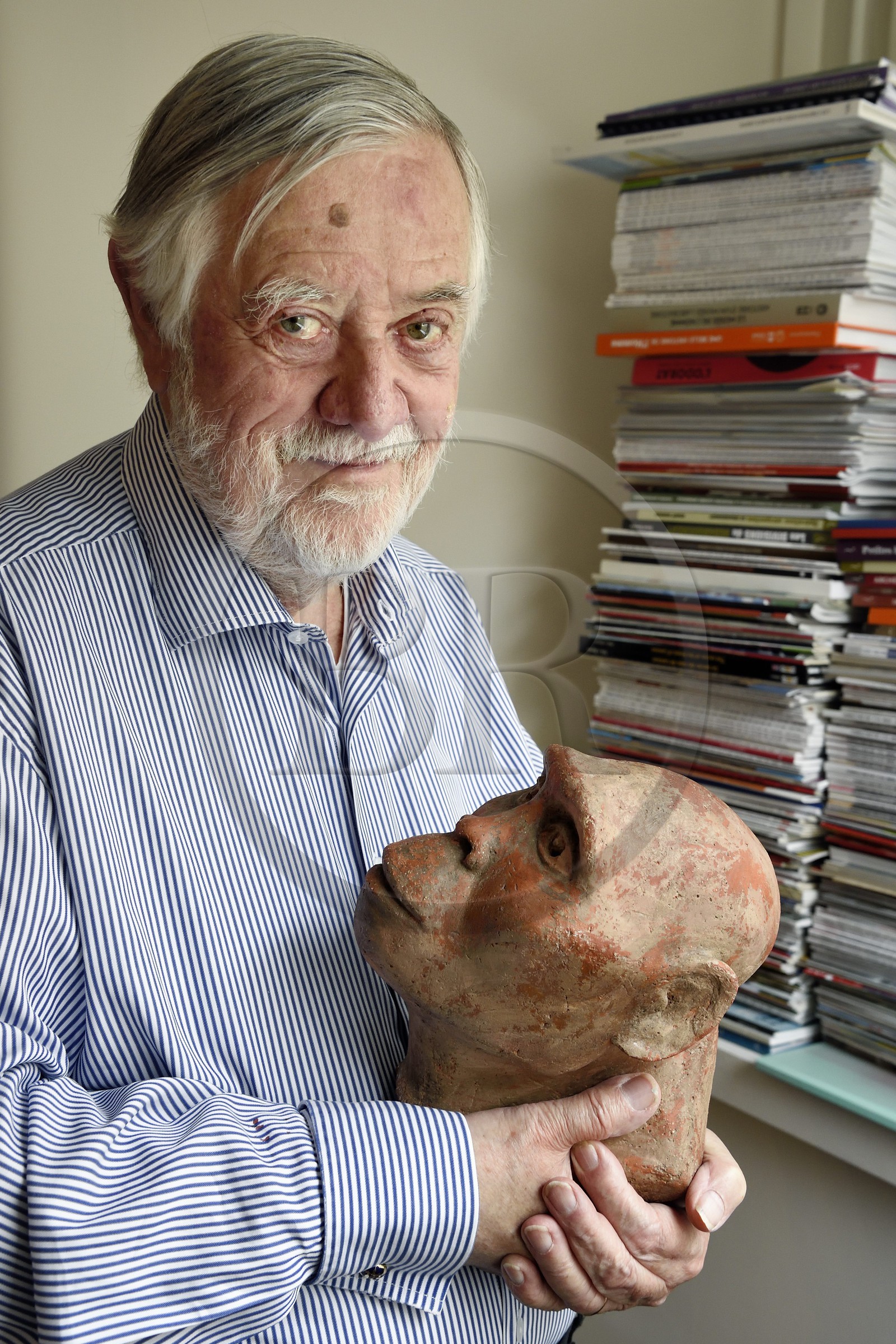 France, Paris, the french paleontologist and paleoanthropologist Yves Coppens, professor at the College de France, in the office of his home in Paris, he holds in his hand the supposed reproduction of Lucy's face