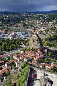 France, Haute Loire, Aiguilhe, a town bordering Puy-en-Velay, Routes of Santiago de Compostela in France listed as World heritage by UNESCO, the Saint-Michel d'Aiguilhe Chapel on a volcanic peak and the 11th century Chateau de Polignac on a basalt plateau in the background, seen from the Notre Dame de France statue on the Rocher Corneille in the foreground