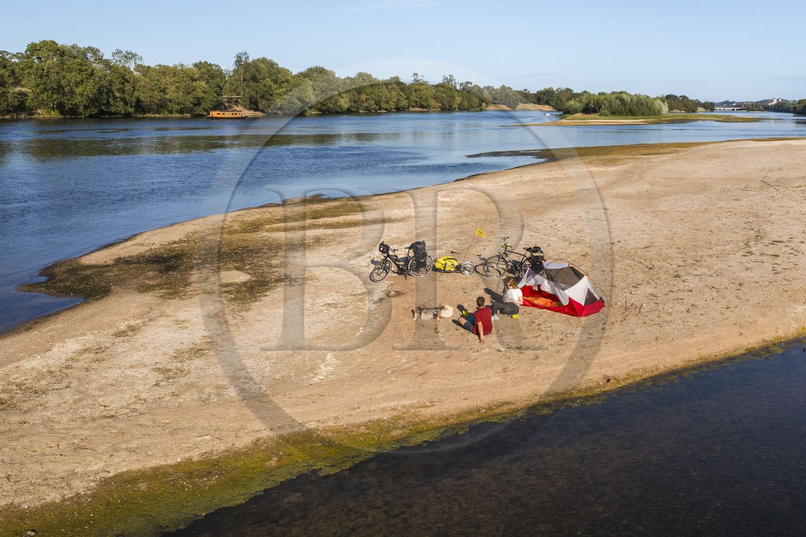 France, Maine-et-Loire, Loire valley listed as World Heritage by UNESCO, cycling along the banks of the Loire, camping for the night on one of the sandbanks forming islands on the Loire, a gabarre (traditional flat-bottomed boat) in the background (aerial view)
