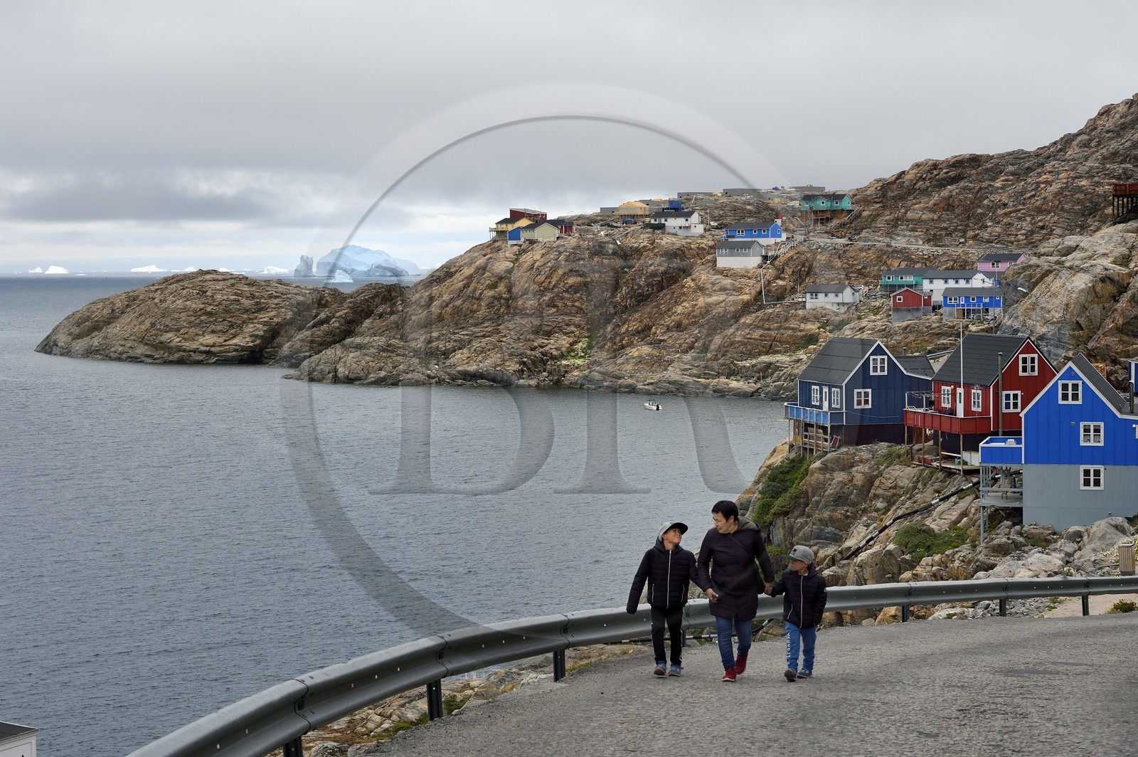 Greenland, west coast, Baffin bay, the town of Uummannaq clinging to the rock and icebergs in the background