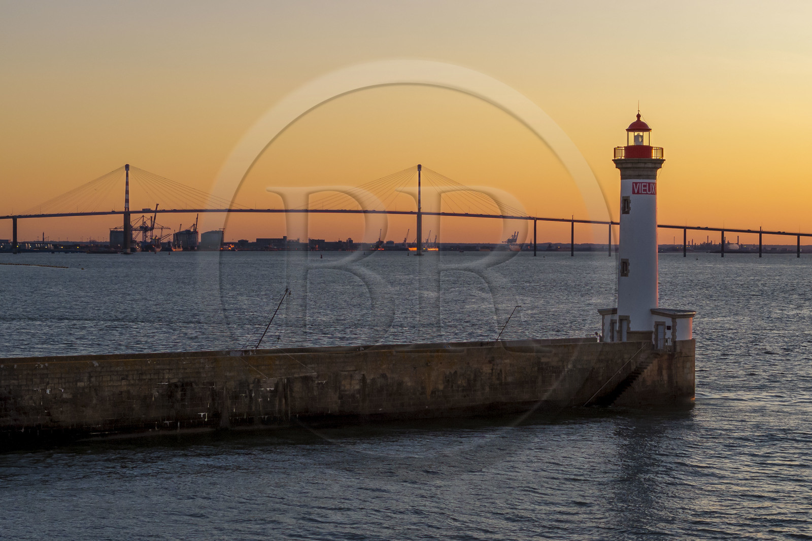 France, Loire-Atlantique, Saint-Nazaire, the Vieux Mole lighthouse and the Saint Nazaire bridge in the background (aerial view)