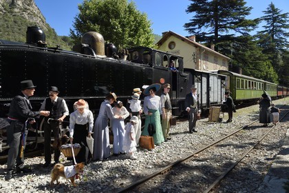 France, Alpes-Maritimes, Puget Theniers, the Train des Pignes historic train, members of the AHVAE (Association d'histoire vivante et de d'archeologie expérimentale) in Belle Epoque costume in front of the steam engine