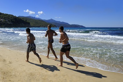 Italy, Tuscany, Elba Island, jogger on the Biodola beach on the North coast