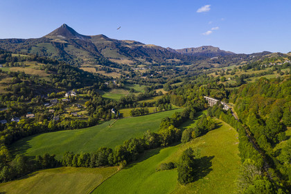 France, Cantal, Parc Naturel Régional des Volcans d'Auvergne (regional nature park of Auvergne volcanoes), Saint Jacques des Blats on the Way of St. James to Santiago de Compostela by Via Arverna, the valley of the Cère, in the background from left to right the Puy Griou, the col de Rombière, the summit of Téton de Venus and the Rocher du Bec de l'Aigle (aerial view)