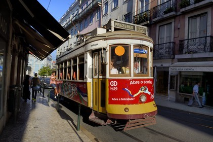 Portugal, Lisbon, Bairro Alto district, child clinging to a tram (electricos) in rua do Loreto