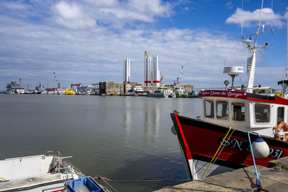 France, Loire-Atlantique, Saint-Nazaire, fishing boats in the harbour basin and the fortified lock of the former German submarine base built during the last world war in the background