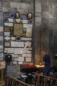 France, Hautes Alpes, Embrun, the 12th century Notre Dame du Real Cathedral, lighting a candle under the Ex-votos
