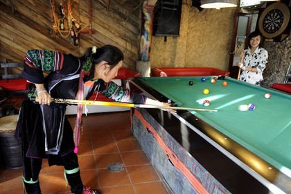 Vietnam, Lao Cai province, city of Sapa, young women from Black Hmong minority group playing pool