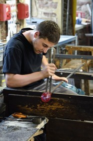 France, Moselle, Meisenthal, Centre international d'Art verrier (CIAV) (international glass centre), the blowing workshop, crafting a Christmas ball, shaping at the outlet of the blow mold