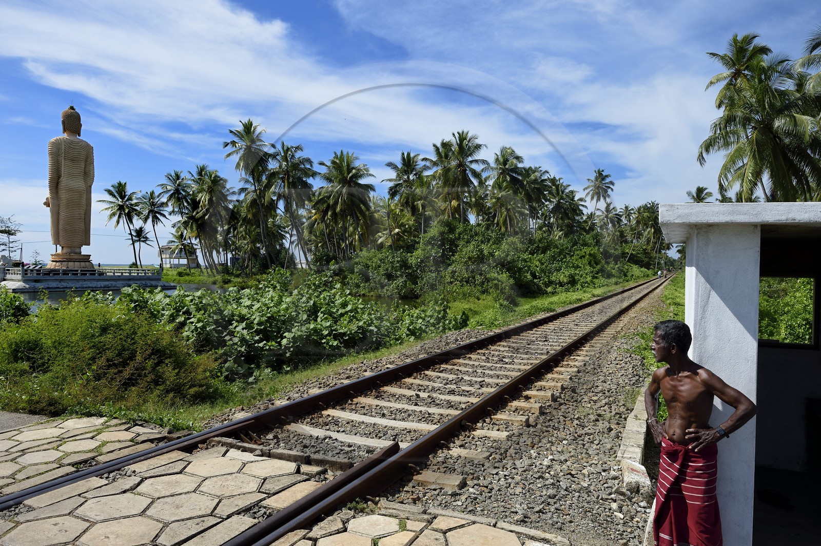 Sri Lanka, Province du Sud, region de Galle, Telwatta, garde-barrière de la voie ferrée de Colombo à Galle devant le Bouddha de Peraliya en memoire des nombreuses victimes du train bondé emporté par le Tsunami du 26 décembre 2004