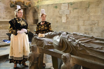 France, Finistère (29), Locronan, labellisé Les Plus Beaux Villages de France, femmes en costume traditionnel pendant la Troménie autours du cénotaphe de saint Ronan dans la chapelle du Péniti adjacente à l'église Saint Ronan