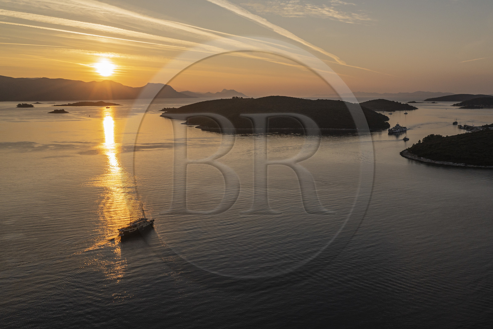 Croatia, Dalmatia, Dalmatian coast, boat sailing at dawn towards archipelago Skoji in the strait between the Peljesac peninsula and Korcula Island (aerial view)