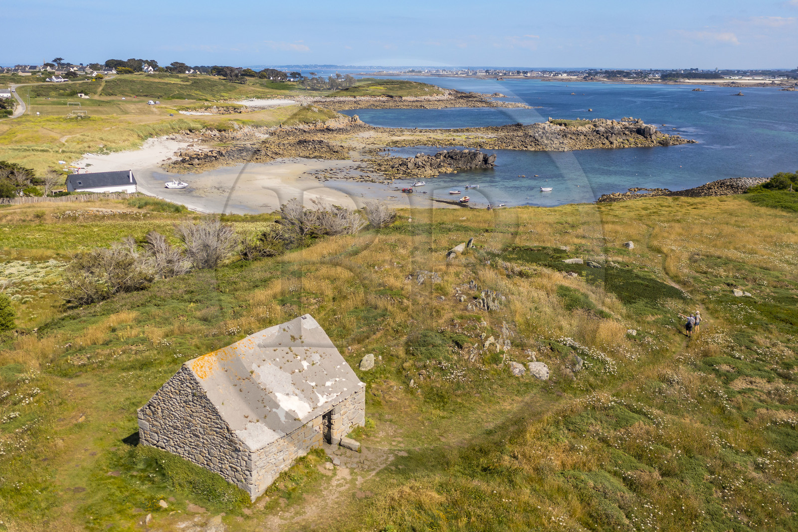 France, Finistère, Ponant Islands, Ile de Batz (Batz Island), former customs house which was the lair of the corsair Balidar and the beach of Porz Reter at low tide in the background (aerial view)
