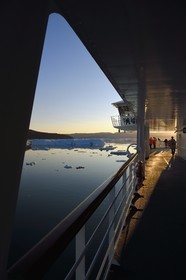 Greenland, west coast, Disko Bay, Hurtigruten's MS Fram Cruise Ship moves between Icebergs in Quervain Bay