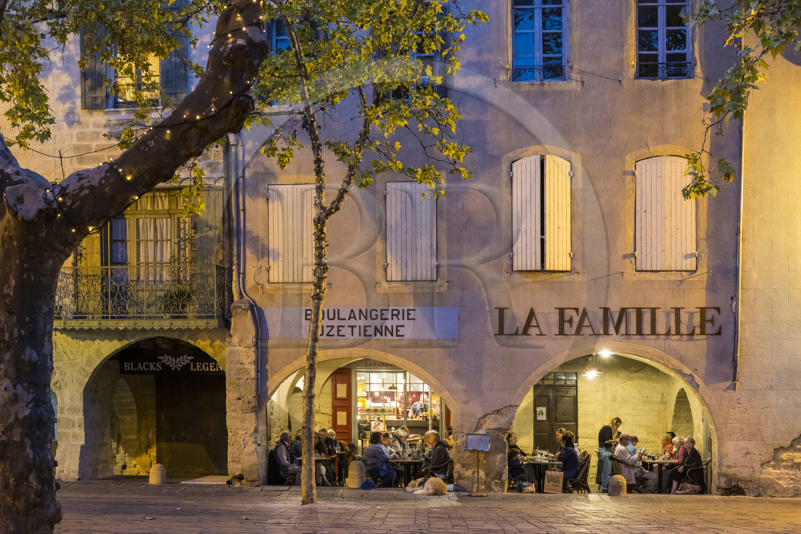 France, Gard, Uzès, the Place aux Herbes surrounded by houses with arcades and its café terraces