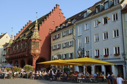 Germany, Baden-Wurttemberg, Freiburg im Breisgau, the Historical Merchants Hall of the early 16th century on the Munsterplatz and Terrace of the restaurant Oberkirch