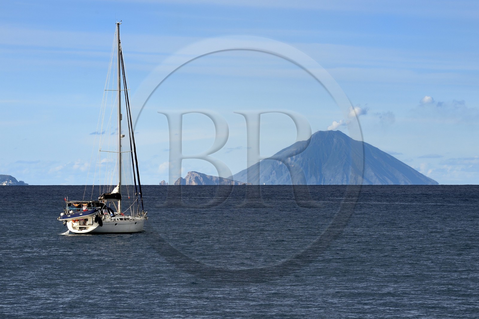 Italy, Sicily, Aeolian Islands, listed as World Heritage by UNESCO, ferry connecting the islands, sailboat sailing to Panarea Island in the center and the Stromboli volcano in the background