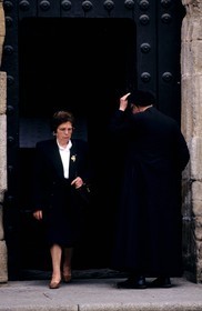 Spain, Estremadura, town of Caceres, a women going out of a church