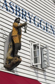 Norway, Hordaland, Bergen, fisherman statue on a wooden house facade