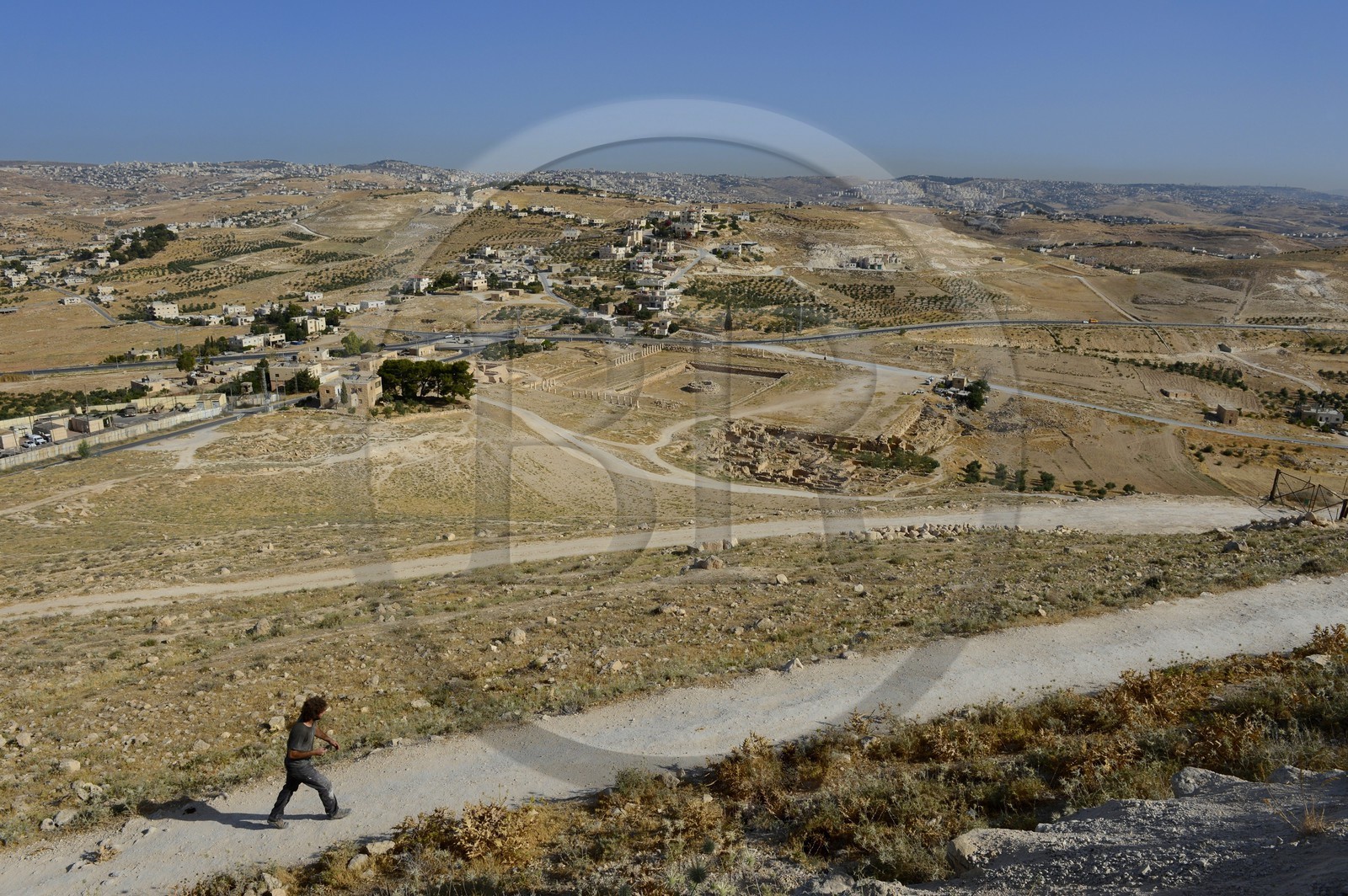 Israel, West Bank, Herodium or Herodion is a volcano-like hill with a truncated cone with a a fortress and palace build by Herod the Great (Herodion National Park), remains of the palace of the lower Herodium and its basin, in the distance Bethlehem