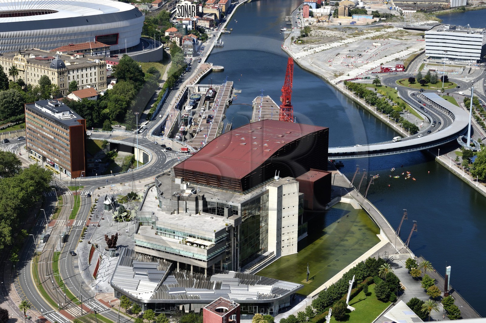 Spain, Basque Country, Biscay Province, Bilbao, the Euskalduna Palace (Palace of Congresses and Music) by the architects Federico Soriano and Dolores Palacios and the Carola crane next to the Ria de Bilbao