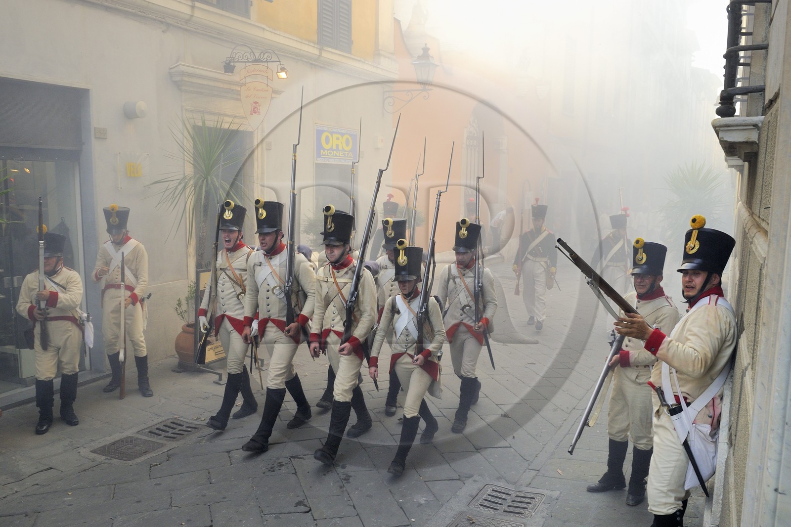 Italy, Liguria, Sarzana, Piazza Matteotti, Napoleon Festival, austrian soldiers firing at the french enemy in the main street Via Mazzini in the old town