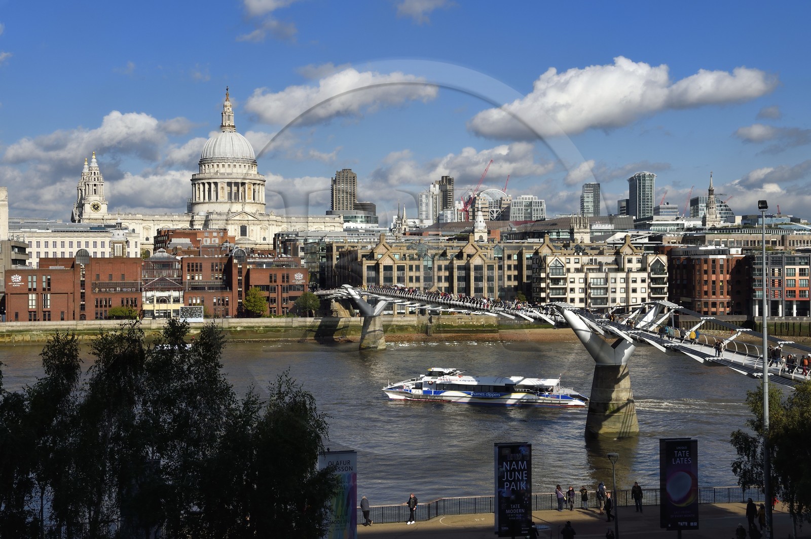 United Kingdom, London, the Millennium Bridge by architect Norman Foster on the Thames river and St. Paul's Cathedral in the district of the City in the background