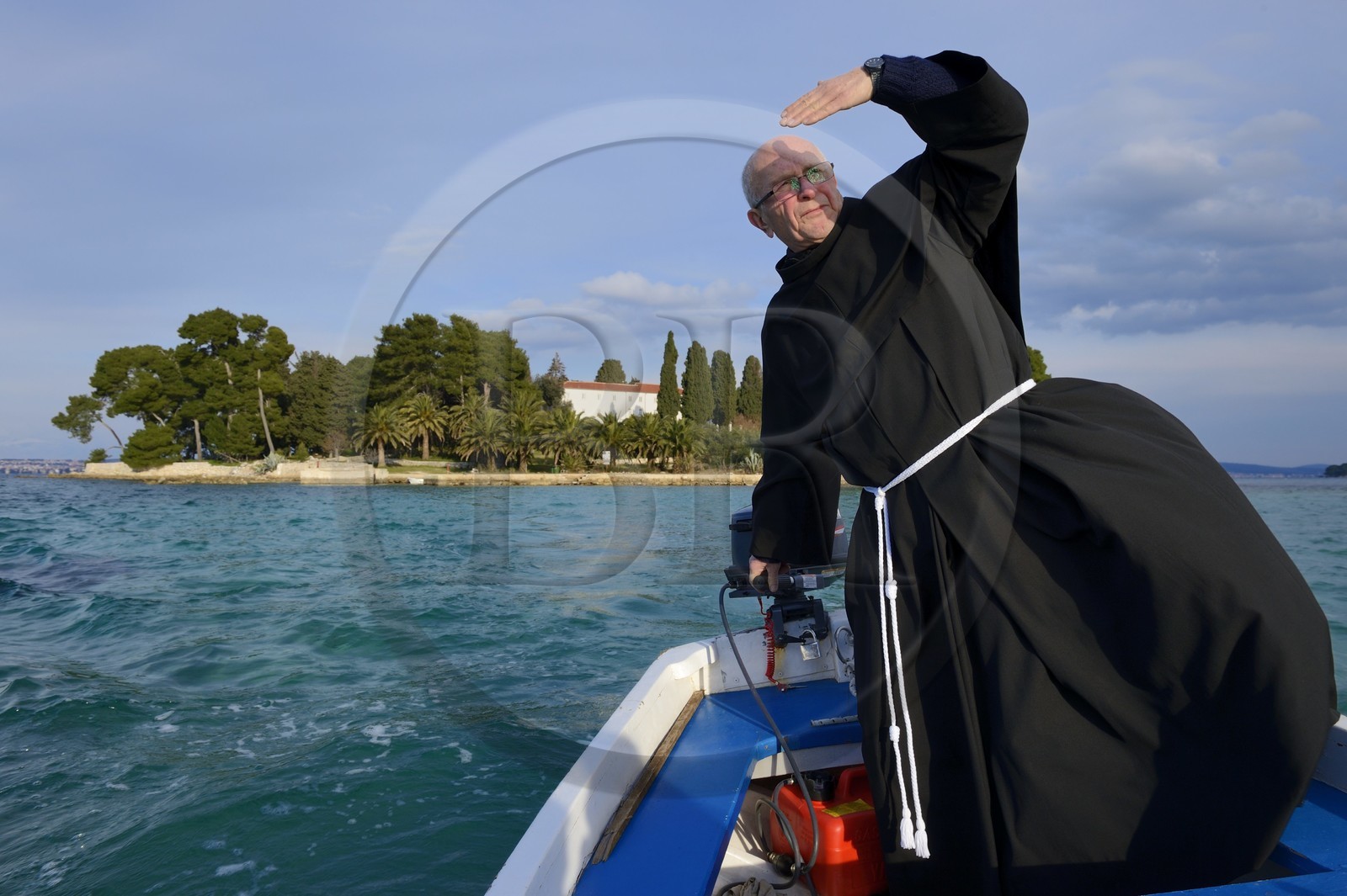 Croatia, Dalmatia, Dalmatian Coast, Ugljan Island, Preko, Franciscan friar Bozo Susic leaving the Franciscan Monastery of the Galovac island on his boat