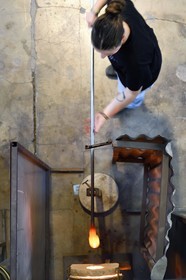 France, Moselle, Meisenthal, Centre international d'Art verrier (CIAV) (international glass centre), the blowing workshop, crafting a Christmas ball, the blower collects a mass of molten glass from the furnace, with his glassmaker's cane