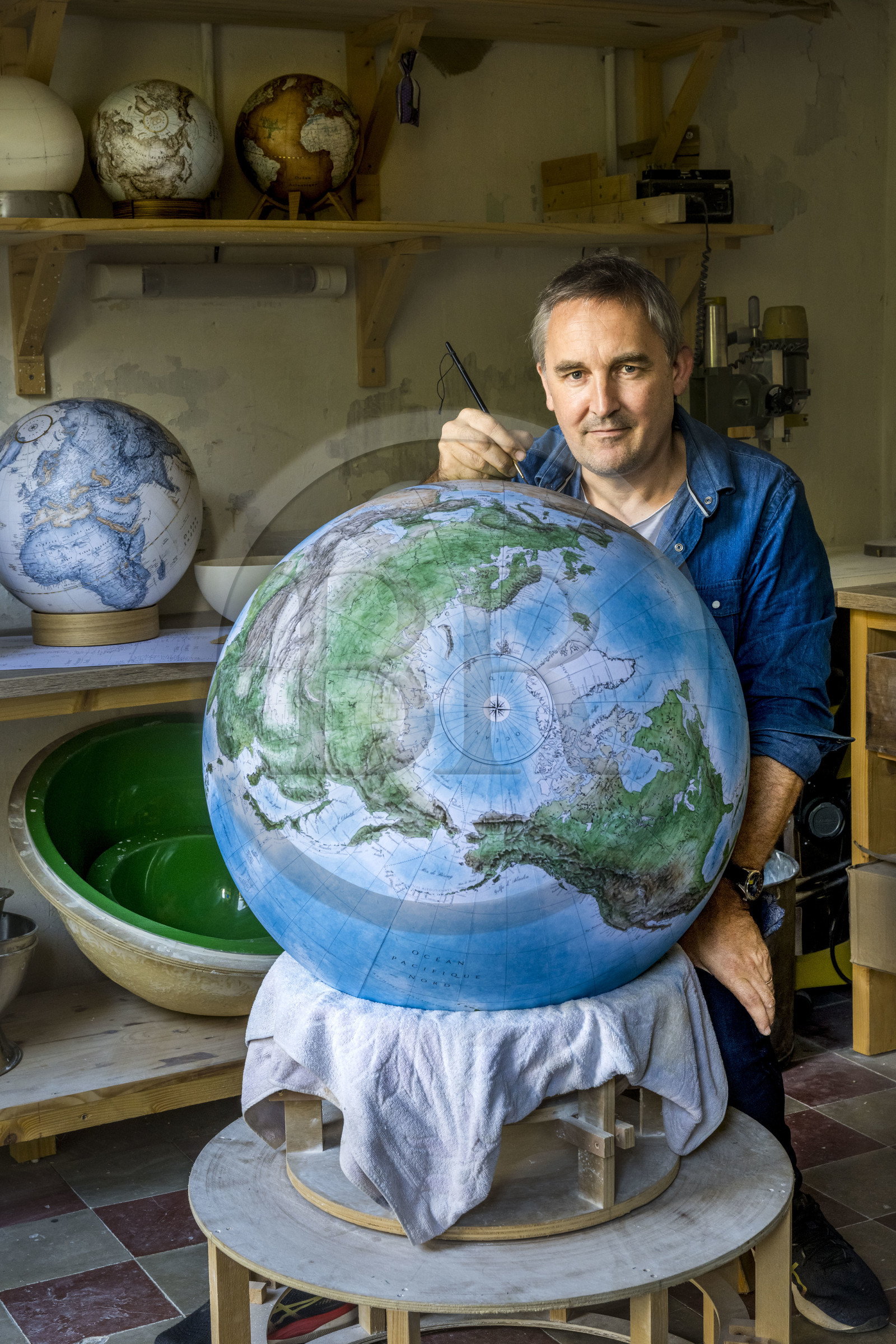 France, Charente, Cognac, Gabriel Gaborel, creator of OrbisTerrae, manufactures handcrafted terrestrial globes painted in watercolor