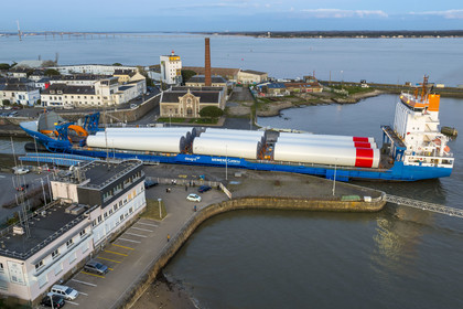 France, Loire Atlantique, Saint Nazaire, The General Cargo Rotra Mare transports sections of wind turbine masts and enters the port's wet dock (in the background) via the south lock, which was also the site of Operation Chariot launched in 1942 by the British (aerial view)