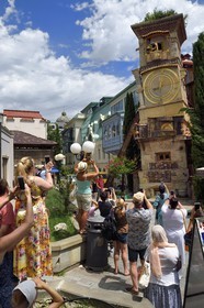 Georgia, Tbilisi, Old City, tourists in front of the Clock tower attached to the Puppet theatre dedicated to Rezo Gabriadze