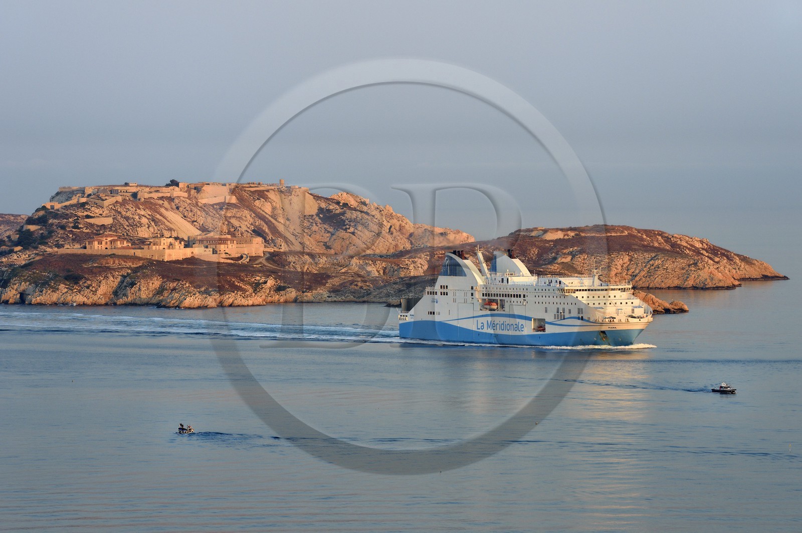 France, Bouches du Rhone, Marseille, Calanques National Park, archipelago of Frioul islands, ferry from La Meridionale arriving from Corsica and the ruins of the Caroline Hospital on the Ratonneau Island in the background