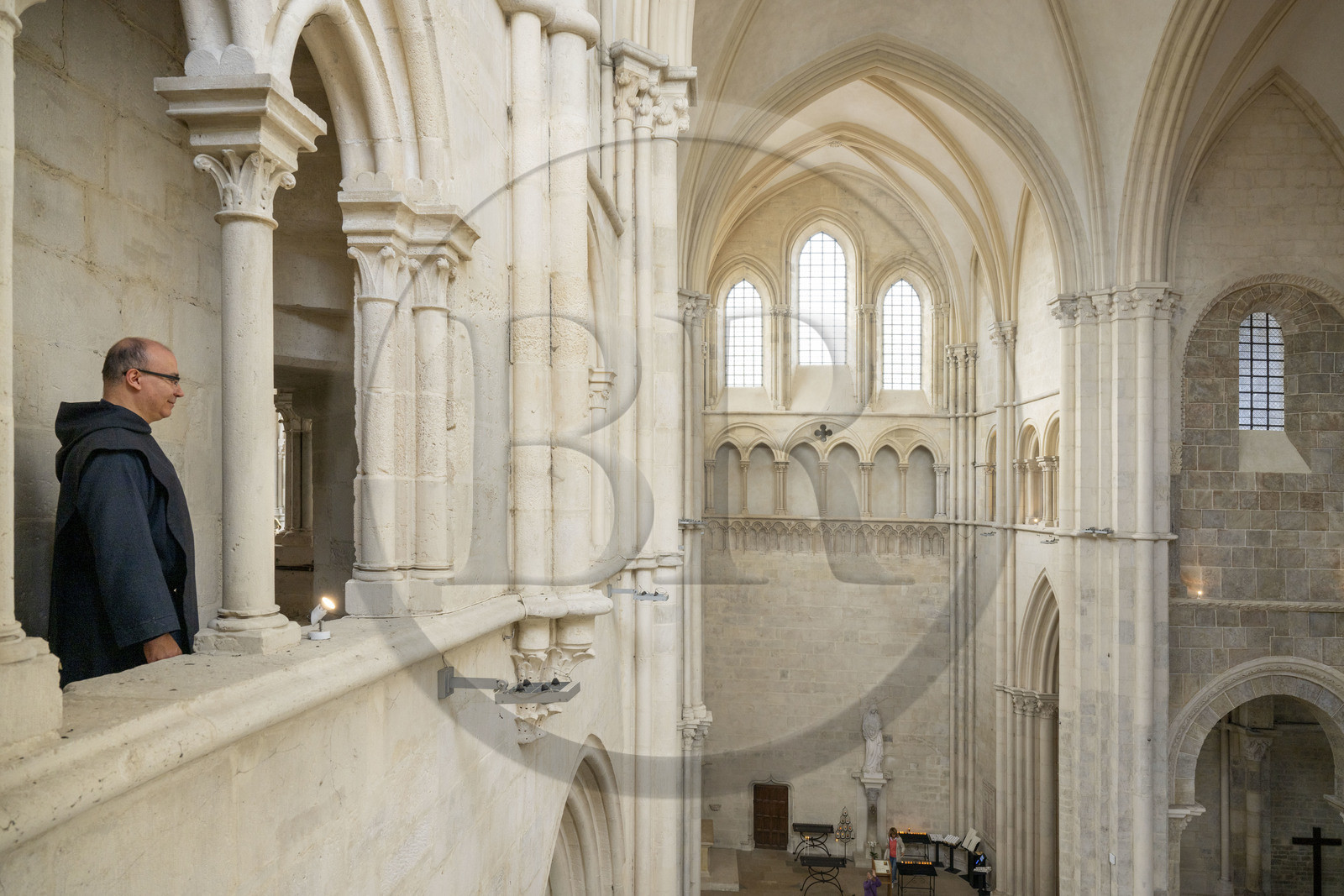 France, Yonne, regional natural park of Morvan, Vézelay, a UNESCO World Heritage site, labelled Les Plus Beaux Villages de France, starting point of one of the main ways to Santiago de Compostela, the Basilica of Saint Mary Magdalene, Brother Matteo of the Jerusalem Fraternity in black tunic and chasuble in the triforium overlooking the transept