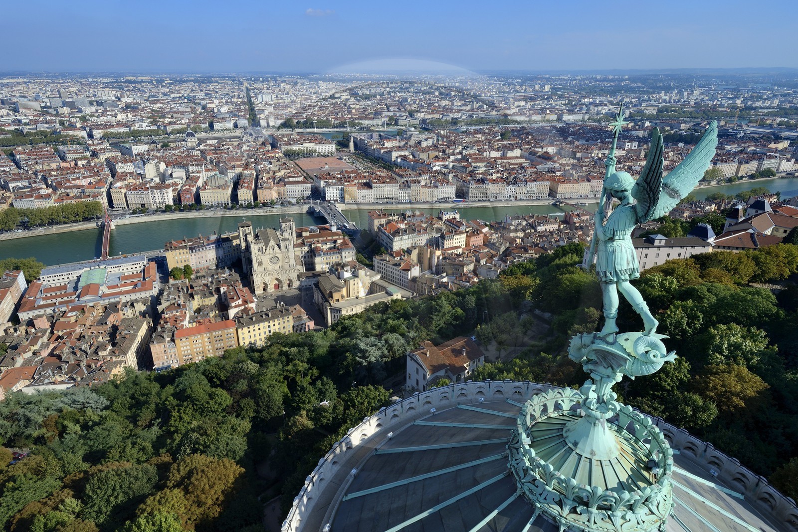 France, Rhone, Lyon, historical site listed as World Heritage by UNESCO, Vieux Lyon (Old Town), the statue of the Archangel Saint Michael slaying the dragon sculpted by Millefaut on the apse of the the Notre Dame de Fourviere Basilica in the foreground, Saint Jean Cathedral (Saint John's Cathedral) and the district of La Presqu'Ile in the background