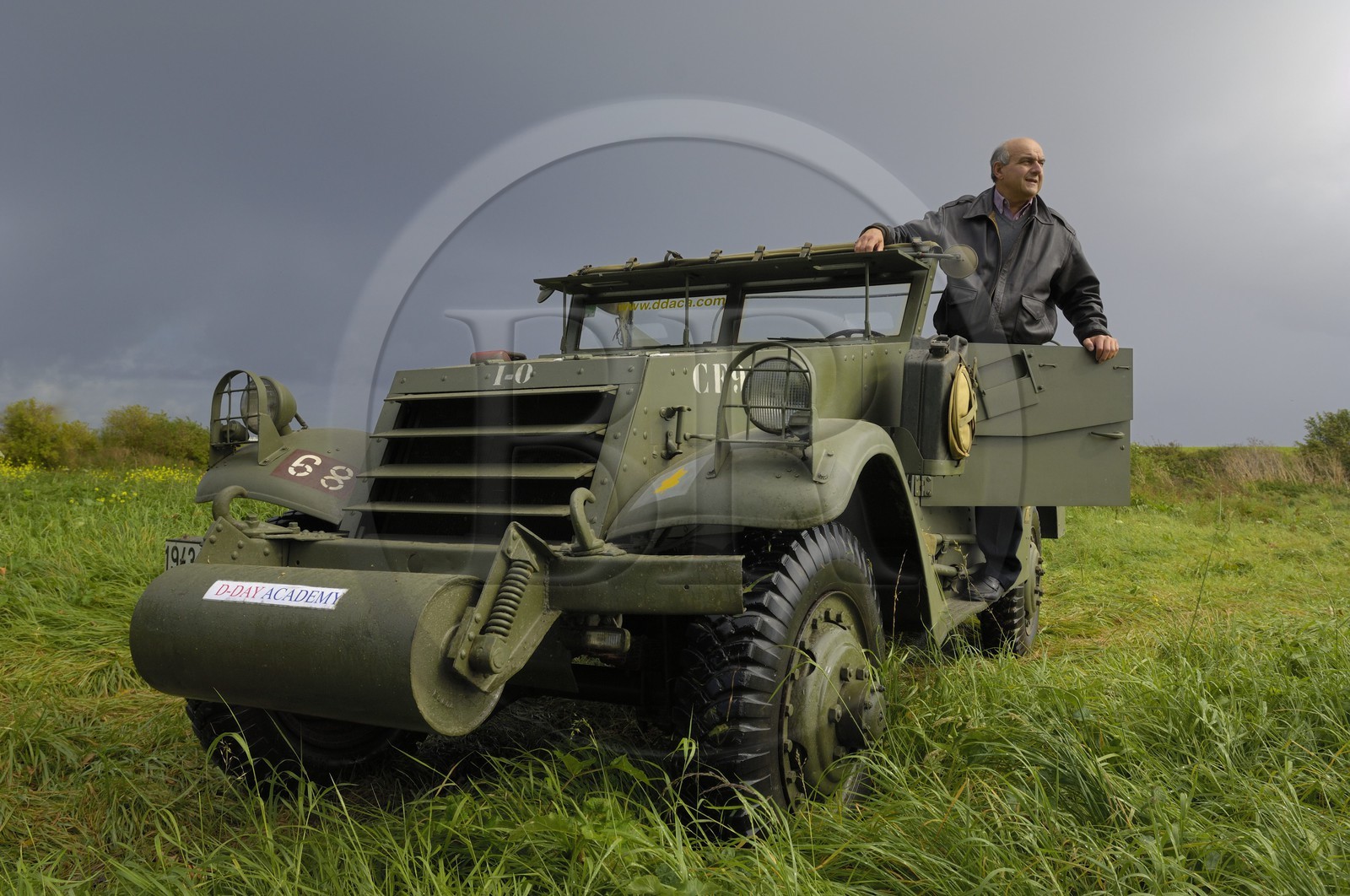 France, Calvados, Caen, Jean Pierre Benamou, president of D-Day Academy guiding visitors on the Normandy landing sites : here a white scout car M3A1