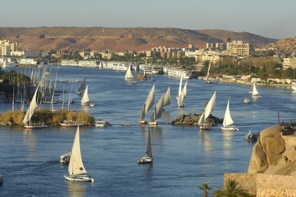 Egypt, Upper Egypt, Nubia, Nile Valley, Aswan, felucca and cruise ship on the Nil, the port in the background