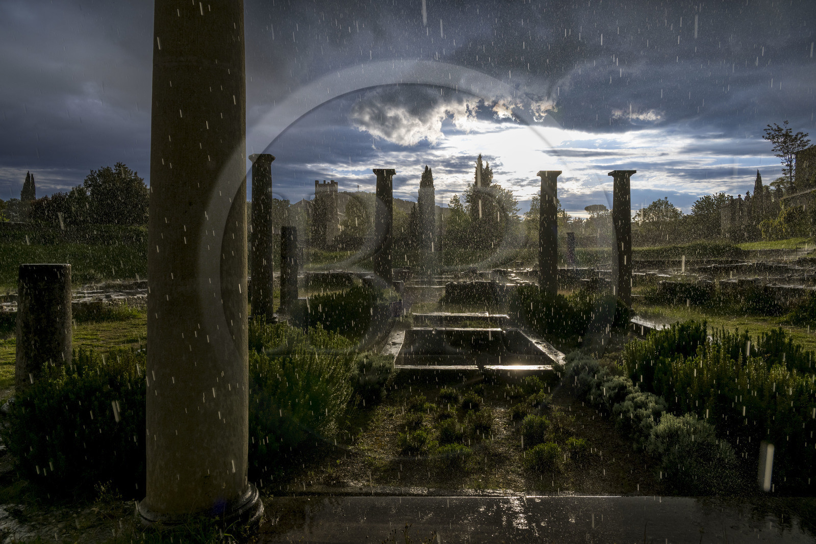France, Vaucluse (84), Dentelles de Montmirail, Vaison-la-Romaine, site archéologique de la Villasse, vestiges de la Maison au Dauphin dont on distingue l’impluvium sous une averse de pluie
