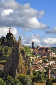 France, Haute Loire, Le Puy en Velay, Routes of Santiago de Compostela in France listed as World heritage by UNESCO, view of the city with the Saint-Michel d'Aiguilhe Chapel perched on a volcanic peak in the foreground, the Notre Dame de France statue (from 1860) on the Rocher Corneille overlooking the 12th century Notre Dame de l'Annonnement cathedral in the background