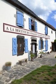 France, Cantal, Parc Naturel Régional des Volcans d'Auvergne (regional nature park of Auvergne volcanoes), step on the Way of St. James to Santiago de Compostela by Via Arverna, Chalinargues, 1806 sign of a former post relay restored identically
